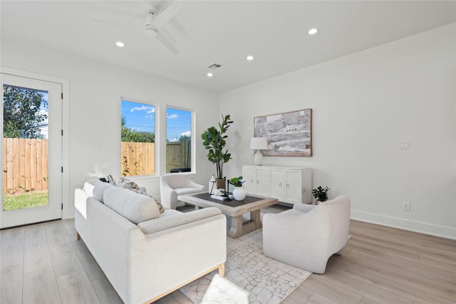 The living area is a warm and inviting space, flooded with natural light from the surrounding windows. Its open yet cozy design makes it perfect for relaxing with family or entertaining guests. With thoughtful touches and a seamless connection to the kitchen and dining areas, it’s the heart of the home where comfort and style come together.