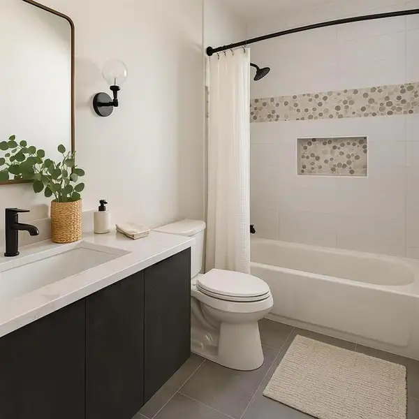 Bathroom featuring vanity, dark tile patterned floors, and shower / tub combo Bathroom featuring vanity, dark tile patterned floors, and shower / tub combo