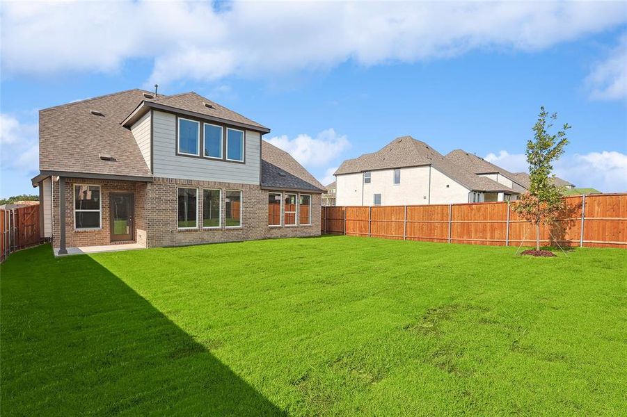 Rear view of house with a yard