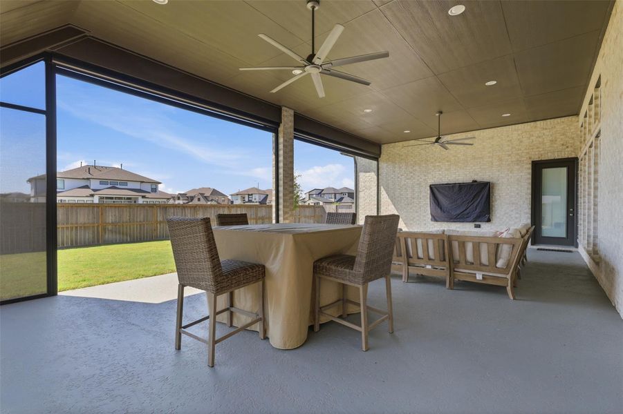 Motorized retractable screens provide theflexibility to enjoy this upgraded covered patioas a screened retreat or open-air outdoor livingspace. Motorized retractable screens provide theflexibility to enjoy this upgraded covered patioas a screened retreat or open-air outdoor livingspace.