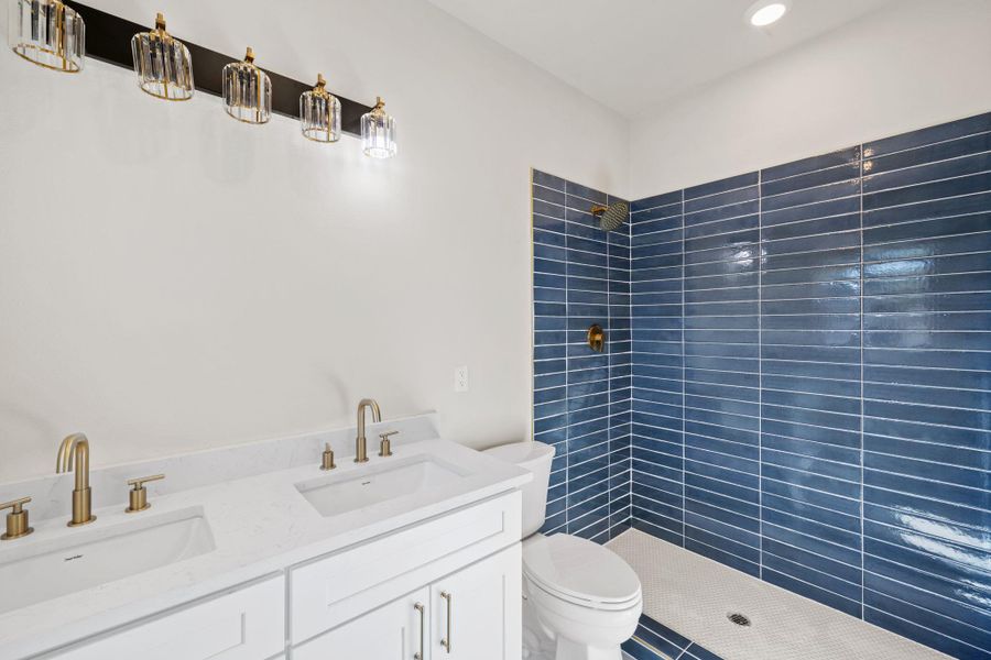 Bathroom with double vanity and tiled shower Bathroom with double vanity and tiled shower