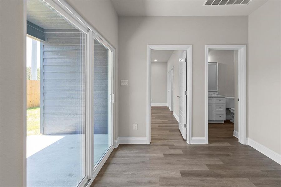 Hall featuring wood-type flooring and entry to backyard