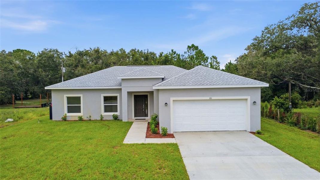 Front exterior of a new home in , Yeehaw Junction, FL, highlighting curb appeal (Image 27).