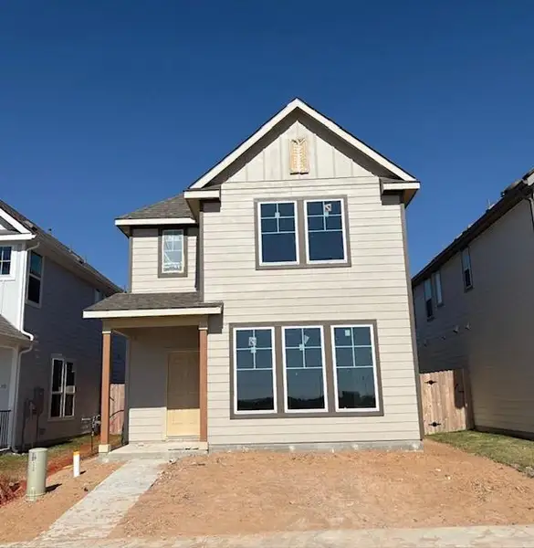 View of front of home featuring a shingled roof, a porch, and board and batten siding