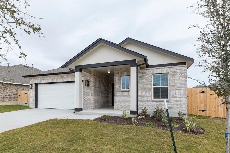 Ranch-style home with brick siding, driveway, and a garage