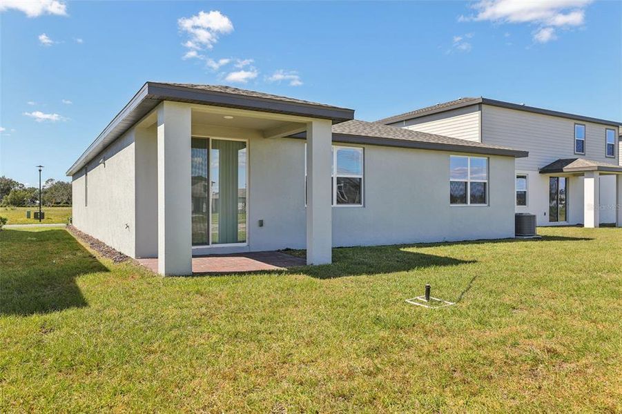 Exterior details and patio area of a home in The Reserve at Twin Lakes, St. Cloud (Image 26).