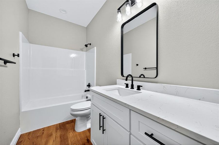 Bathroom with shower / bathtub combination, dark wood-type flooring, and vanity Bathroom with shower / bathtub combination, dark wood-type flooring, and vanity