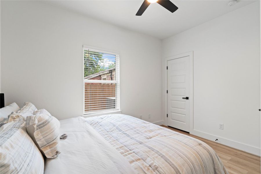 Each secondary bedroom is framed by large windows offering private views of the fenced yard and natural light all day.