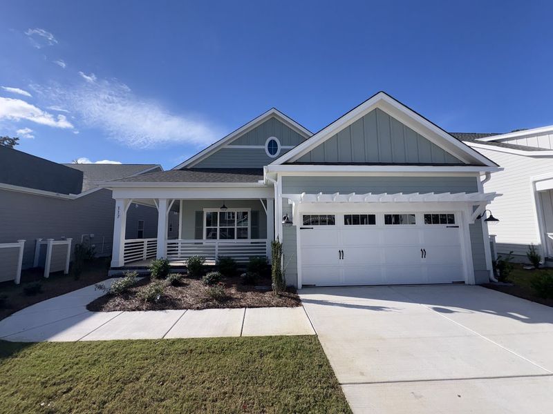 Front exterior of a new home in Riverside Cove, Wilmington, NC, highlighting curb appeal (Image 1). Front exterior of a new home in Riverside Cove, Wilmington, NC, highlighting curb appeal (Image 1).