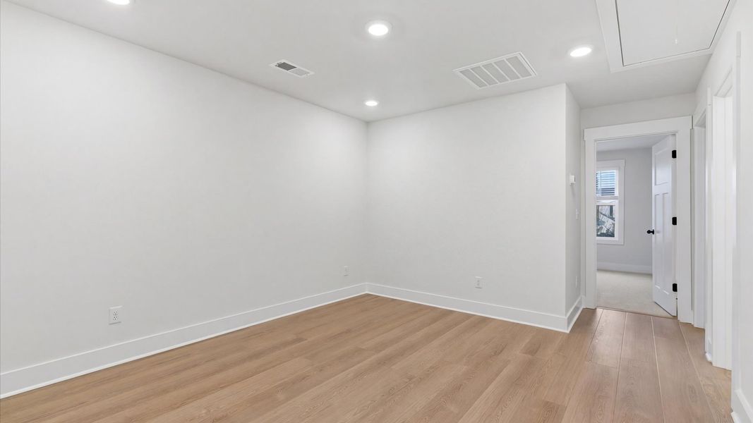 Functional loft with tasteful hardwood floors and exceptional natural light in a modern villa at Pelham Crossing