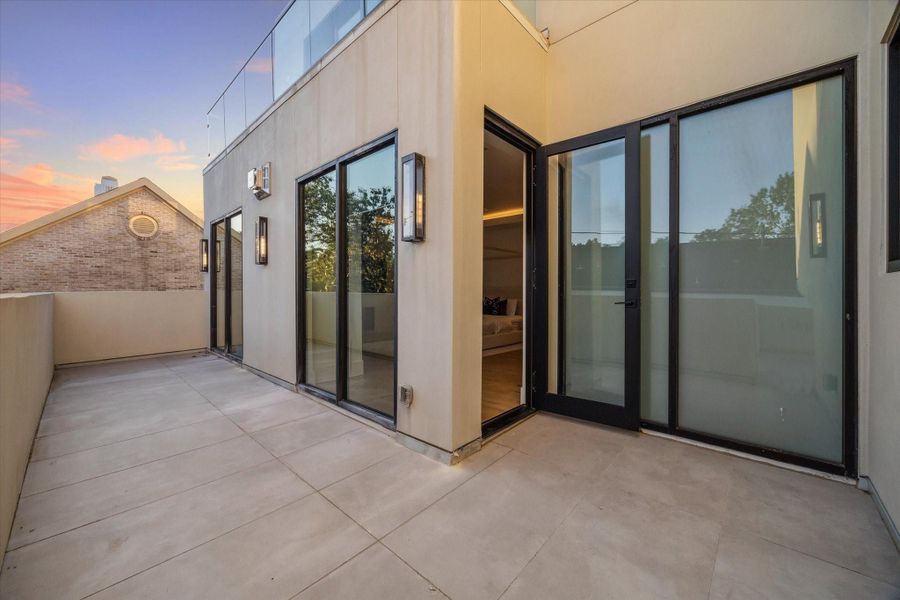 Primary suite private terrace with pool views