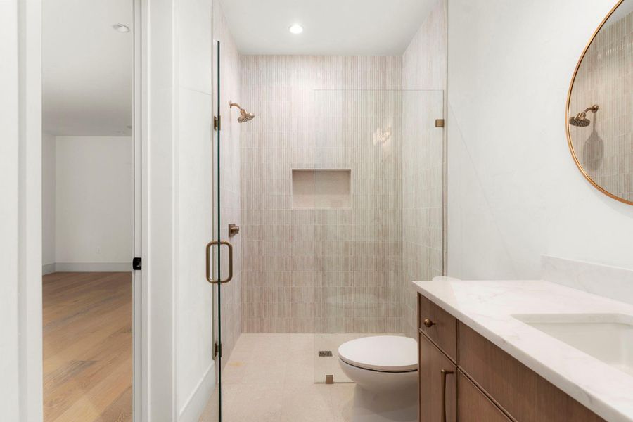Bathroom featuring vanity, a stall shower, recessed lighting, and light wood finished floors
