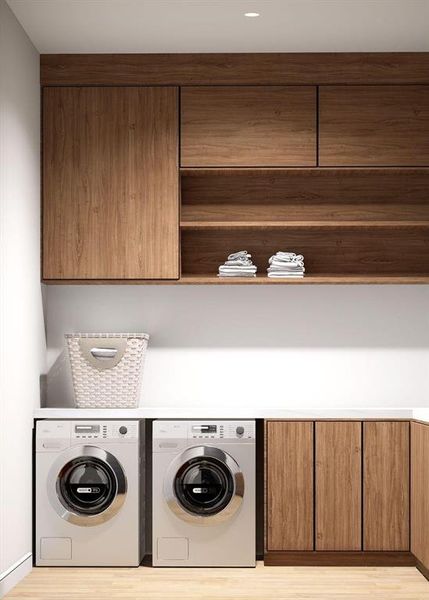 Laundry area featuring cabinet space, independent washer and dryer, and light wood-style floors