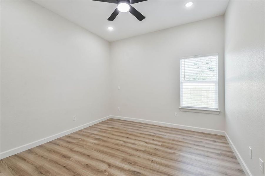 Large secondary bedroom with wood look tile - no carpet!