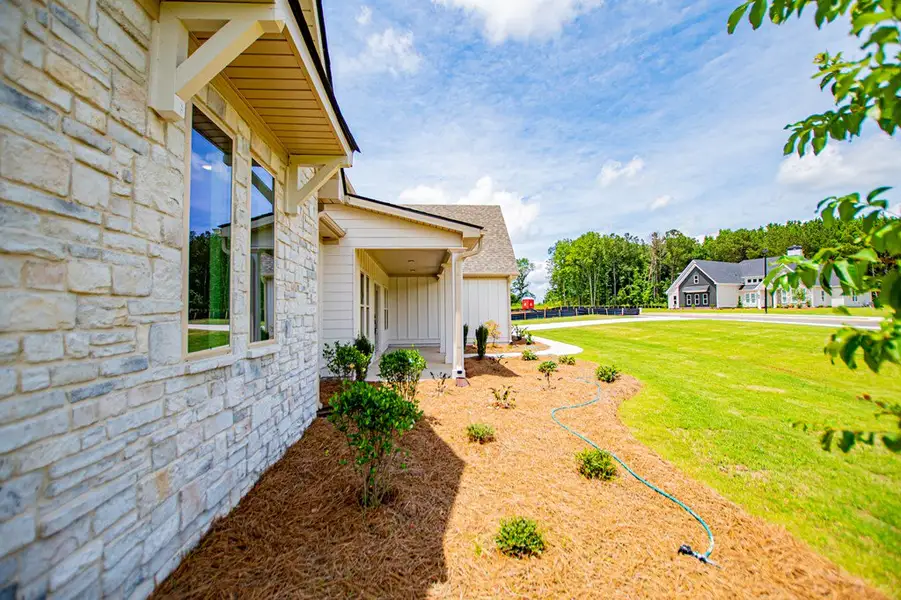 Exterior details and patio area of a home in WOODMONT RESERVE, Roopville (Image 35).