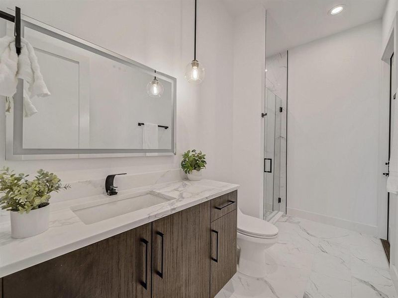 Full bathroom with vanity, marble finish flooring, a marble finish shower, and recessed lighting