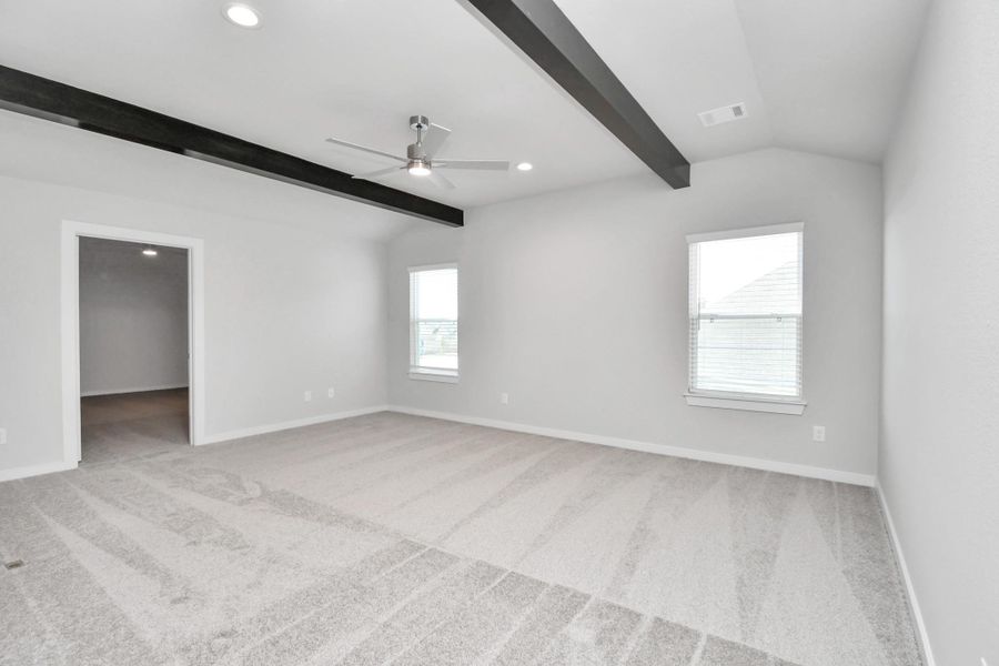 Ascend to relaxation in this fantastic game room! Ideal for both casual gatherings and adult gaming, it boasts plush carpet, lofty ceilings, custom paint, and ample windows for abundant natural light. Sample photo of completed home with similar floor plan. Actual colors and selections may vary.