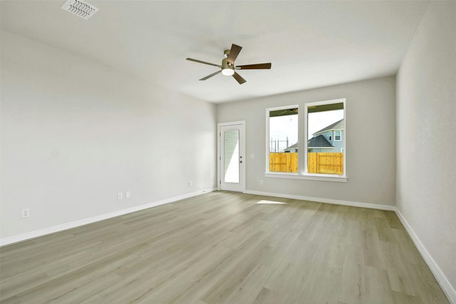 Unfurnished room featuring ceiling fan and light hardwood / wood-style flooring