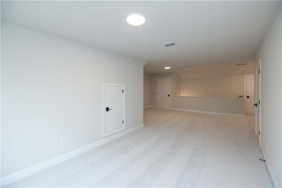 Unfurnished room featuring light carpet and recessed lighting