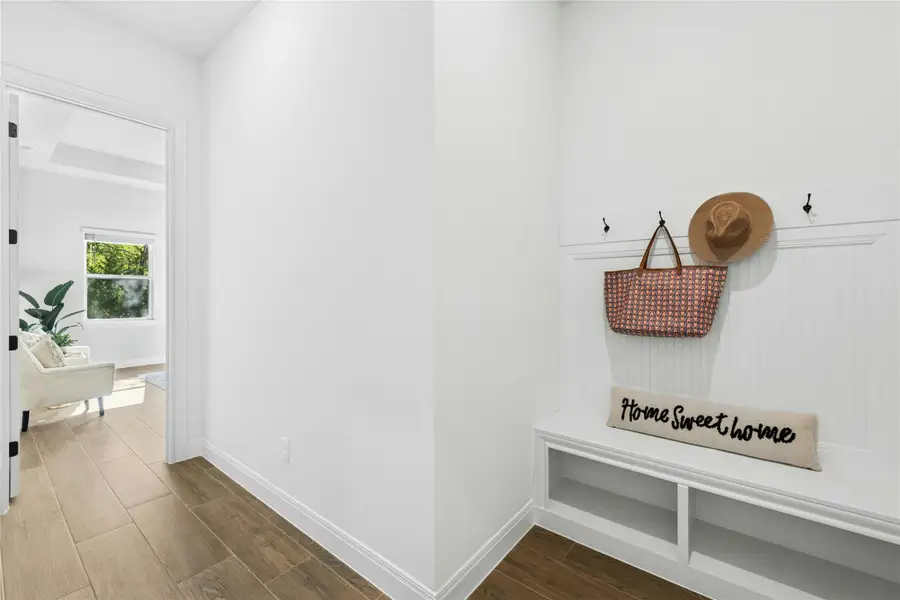Mudroom with dark wood-type flooring and baseboards Mudroom with dark wood-type flooring and baseboards