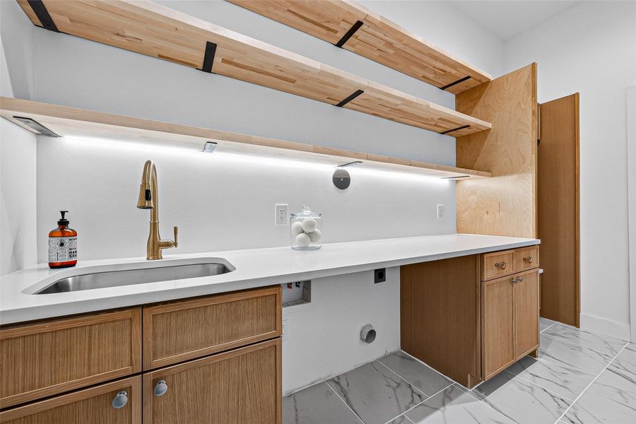 Amazing laundry room with storage shelves, washer/dryer connections Amazing laundry room with storage shelves, washer/dryer connections