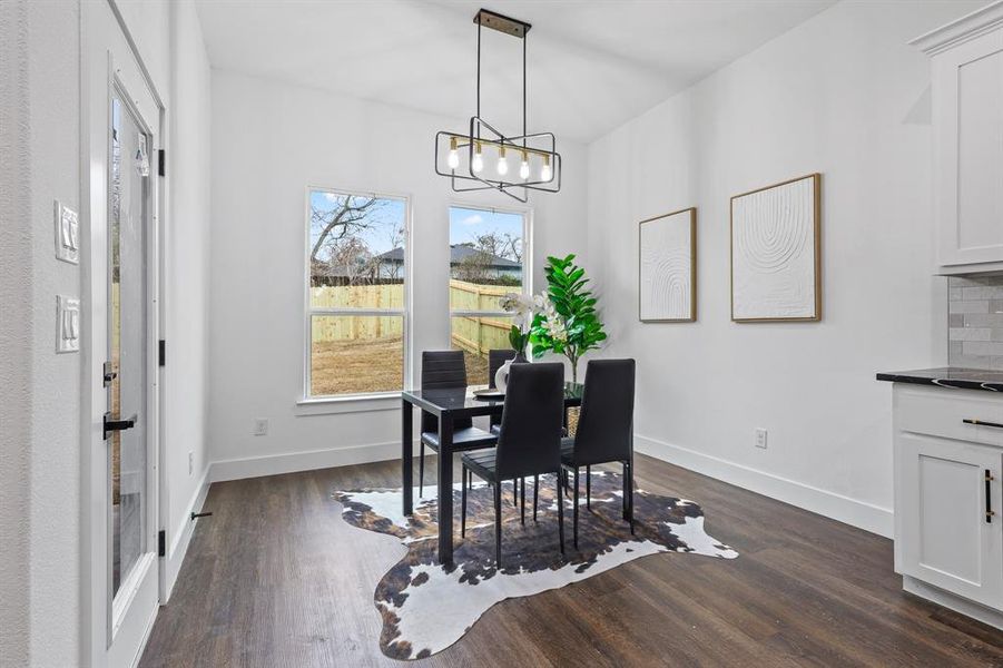 Dining room with an inviting chandelier and dark hardwood / wood-style flooring