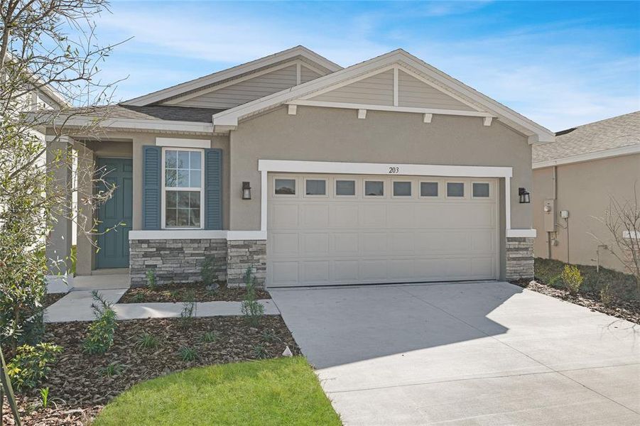 Front exterior of a new home in Seasons at Magnolia Pointe, Umatilla, FL, highlighting curb appeal (Image 1).