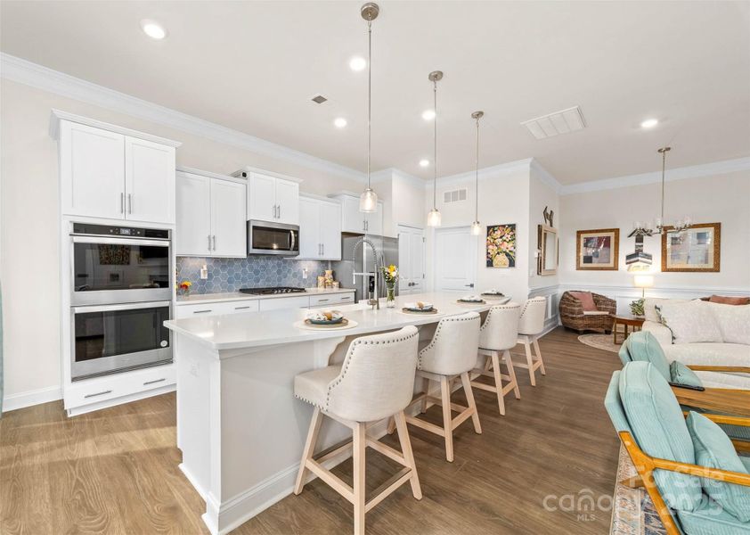 Kitchen island with pendant lights and quartz countertops