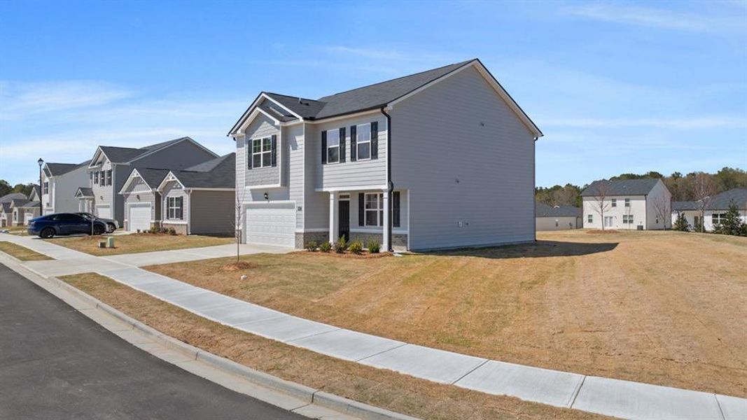 Front exterior of a new home in Champion's Run, Lithonia, GA, highlighting curb appeal (Image 25).
