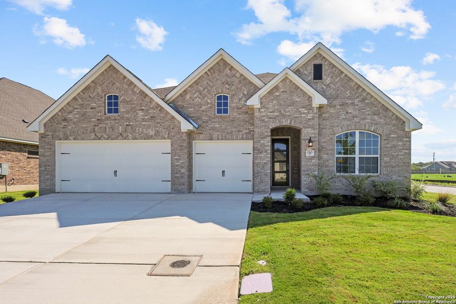Front exterior of a new home in Megan's Landing, Castroville, TX, highlighting curb appeal (Image 18).