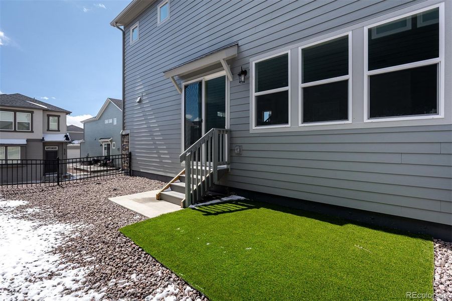Exterior details and patio area of a home in Revel Crossing at Wolf Ranch – The Ascent Collection, Colorado Springs (Image 1).