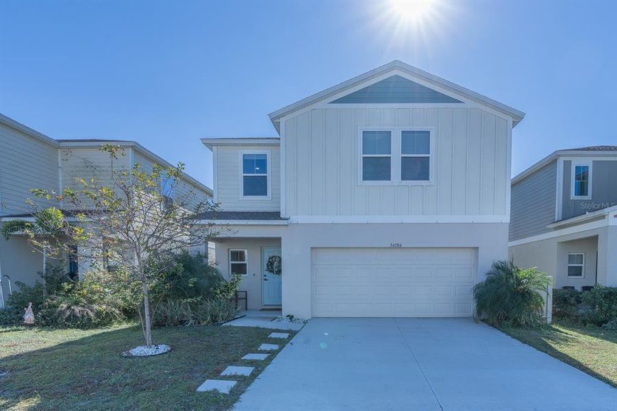 Front exterior of a new home in Pasadena Point, Wesley Chapel, FL, highlighting curb appeal (Image 26). Front exterior of a new home in Pasadena Point, Wesley Chapel, FL, highlighting curb appeal (Image 26).
