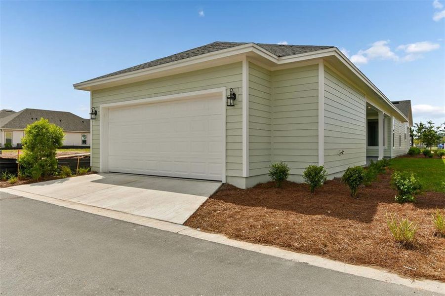 Front exterior of a new home in Weslyn Park in Sunbridge 34', St. Cloud, FL, highlighting curb appeal (Image 18).