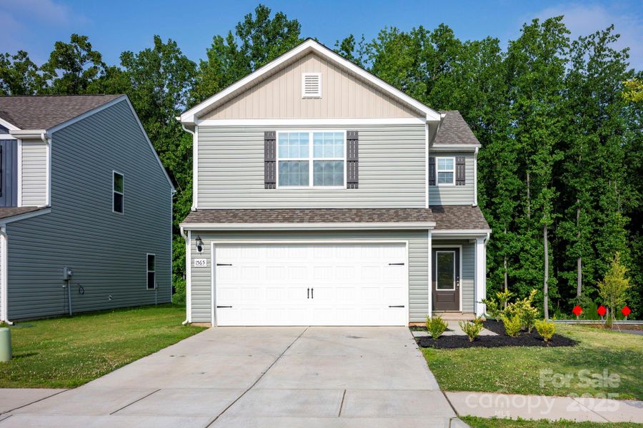Front exterior of a new home in McKee Creek Village, Charlotte, NC, highlighting curb appeal (Image 1).
