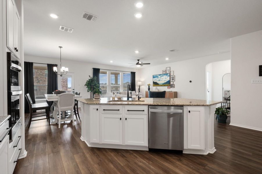 Kitchen featuring white cabinets, stainless steel appliances, dark wood-type flooring, a ceiling fan, and open floor plan