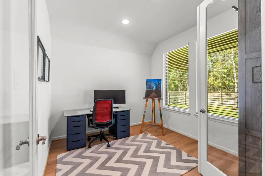 The home office is located at the rear of the home overlooking the expansive backyard.