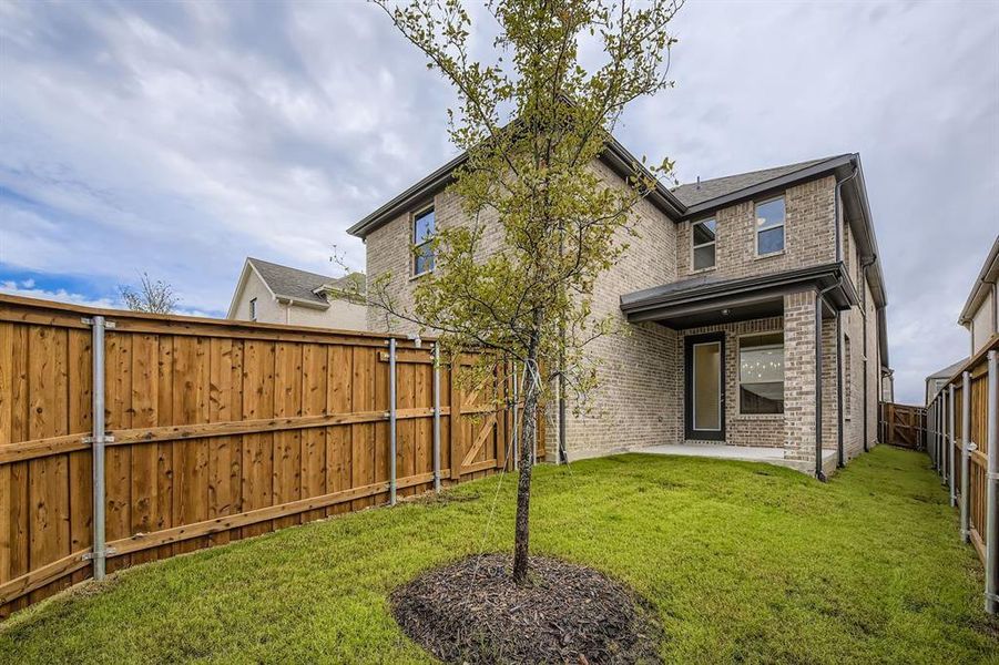 Back of house featuring a patio area, a fenced backyard, and brick siding Back of house featuring a patio area, a fenced backyard, and brick siding