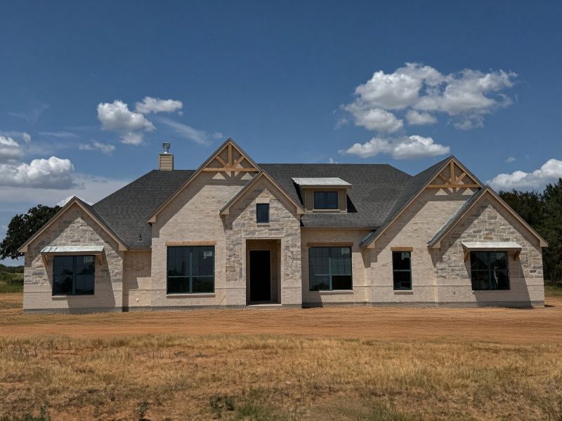 Front exterior of a new home in Overton Oaks, Paradise, TX, highlighting curb appeal (Image 1). Front exterior of a new home in Overton Oaks, Paradise, TX, highlighting curb appeal (Image 1).