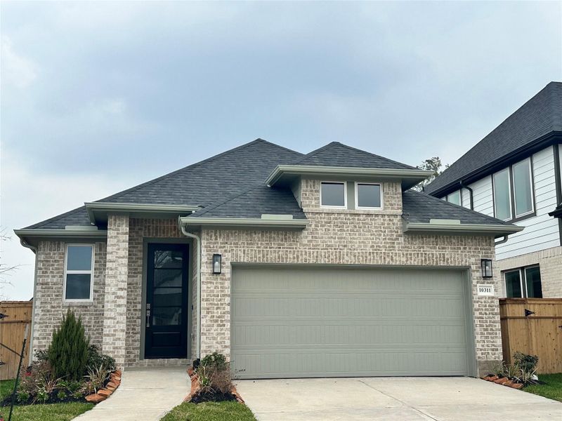 Front exterior of a new home in Sienna, Missouri City, TX, highlighting curb appeal (Image 2).