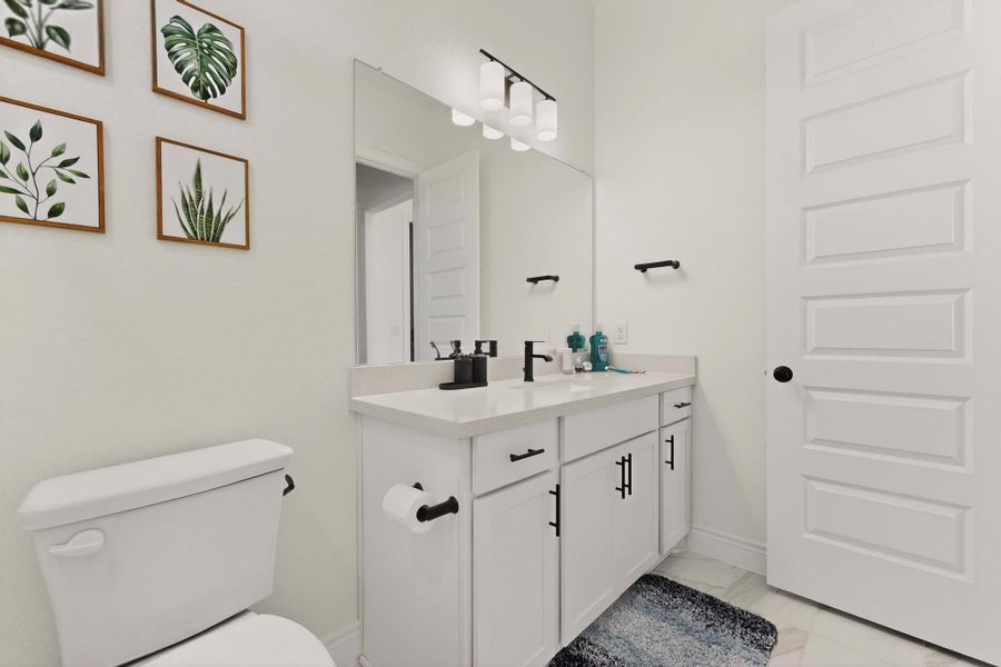Bathroom featuring vanity and light marble finish floors