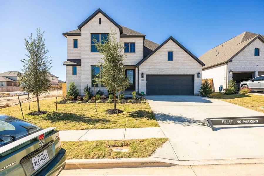 Front exterior of a new home in Nolina 60', Georgetown, TX, highlighting curb appeal (Image 2).