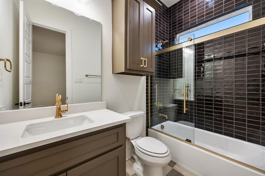Bathroom with shower / bath combination with glass door and vanity