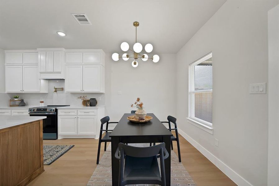 Dining space with light wood-style flooring, a chandelier, and recessed lighting Dining space with light wood-style flooring, a chandelier, and recessed lighting