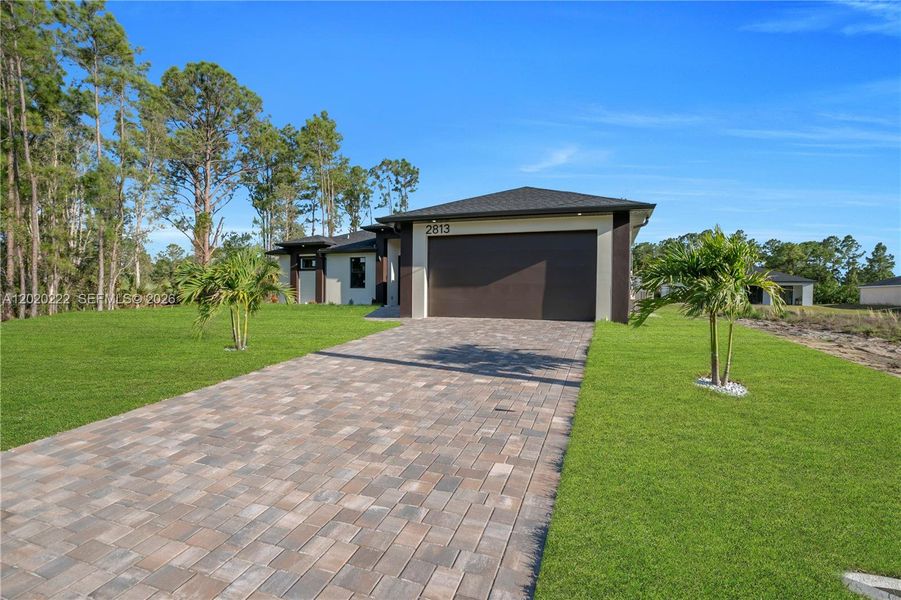 Front exterior of a new home in , Lehigh Acres, FL, highlighting curb appeal (Image 26).