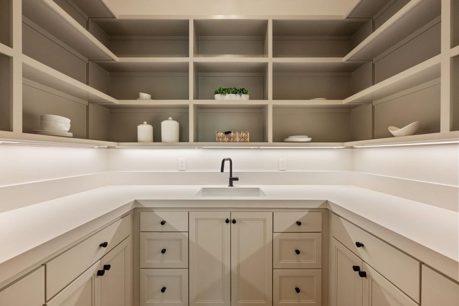 Ample storage solutions and a convenient prep sink define this well-appointed pantry. Ample storage solutions and a convenient prep sink define this well-appointed pantry.
