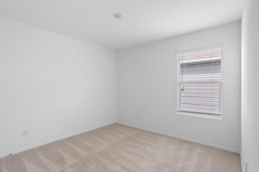 Unfurnished room featuring light colored carpet and baseboards