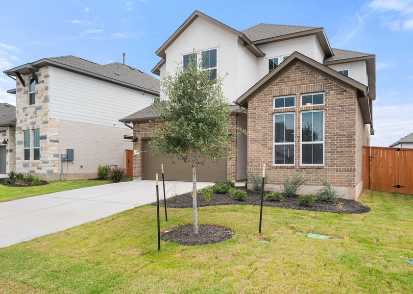 Front exterior of a new home in Arbor Collection at Lariat, Liberty Hill, TX, highlighting curb appeal (Image 2). Front exterior of a new home in Arbor Collection at Lariat, Liberty Hill, TX, highlighting curb appeal (Image 2).