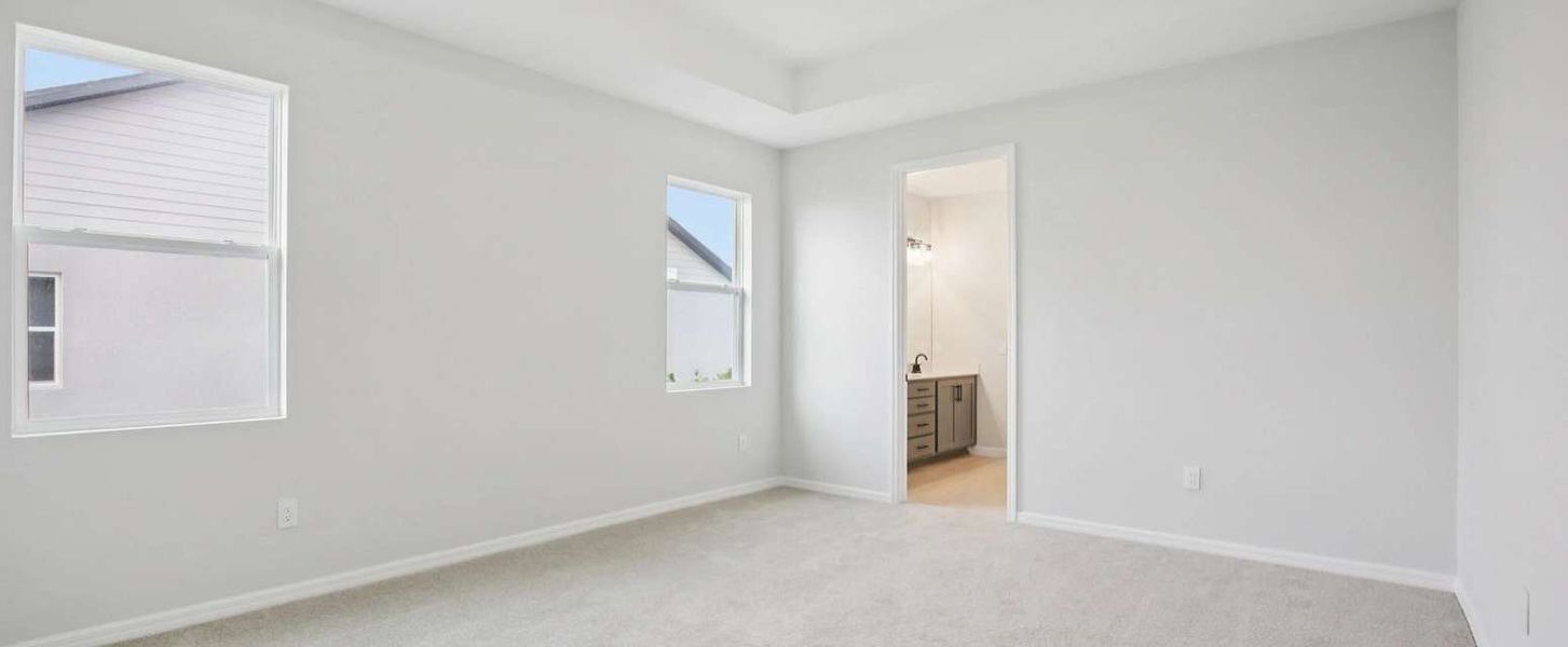 Primary bedroom featuring a tray ceiling - Representative images and renderings are for illustrative purposes