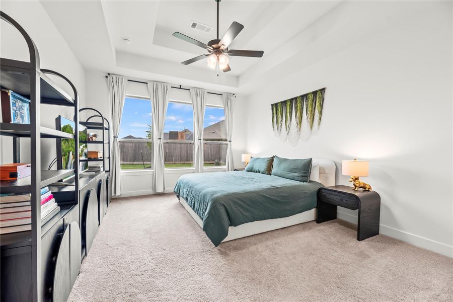 You'll have sweet dreams in this posh owner's retreat with soft neutral finishes, a raised tray ceiling, triple windows, a deep walk-in closet (that connects to the utility room), and a true spa-like ensuite. It's the perfect space to rest and recharge.