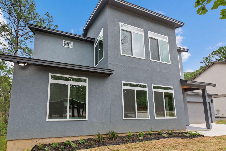 Modern architecture defines this dwelling, showcasing large, clear windows and clean lines.